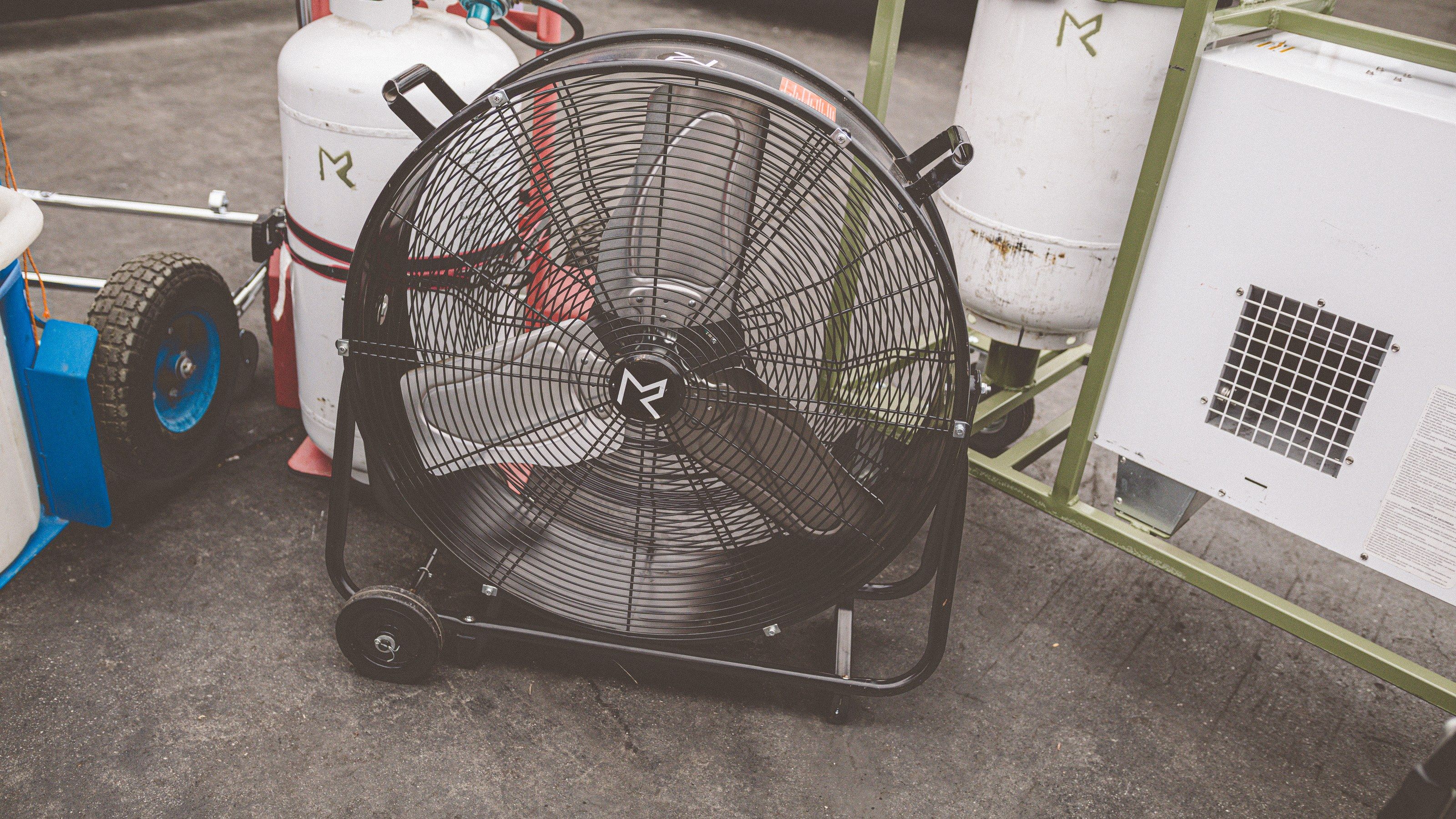 Drum fan beside a portable AC unit