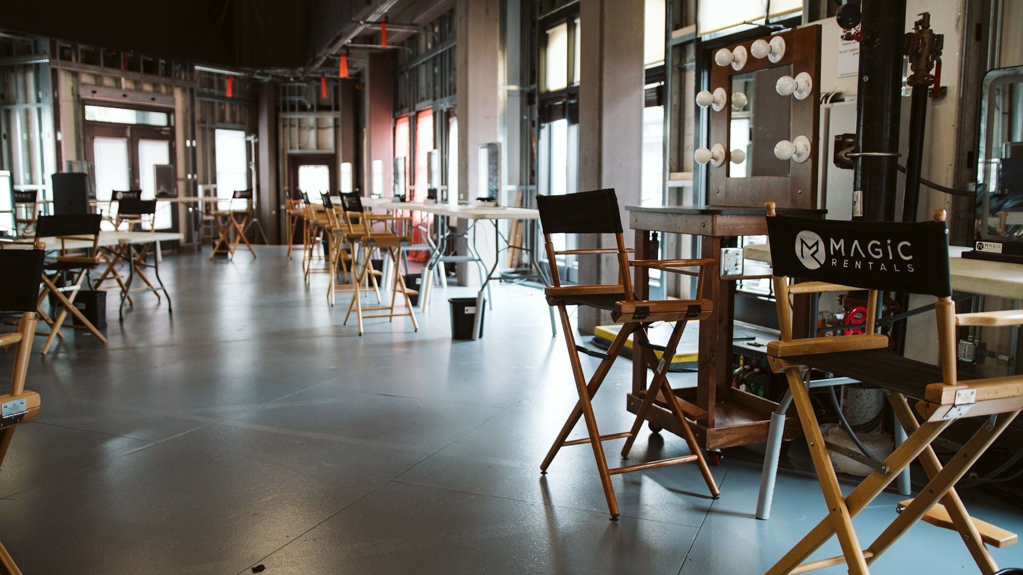 Rows of stations and director chairs on a stage floor